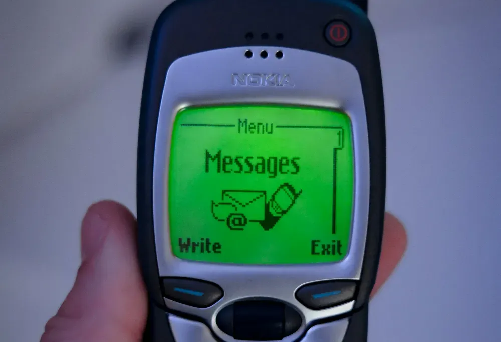 a hand holding a cell phone with a message message on it